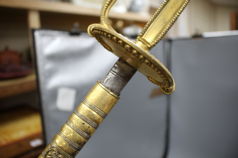 A cut steel dress sword by Ede & Ravenscroft of London and two brass hilted dress swords